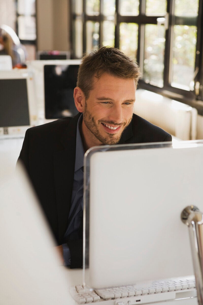 business-man-in-office-using-laptop-portrait-2024-09-15-16-40-54-utc-1